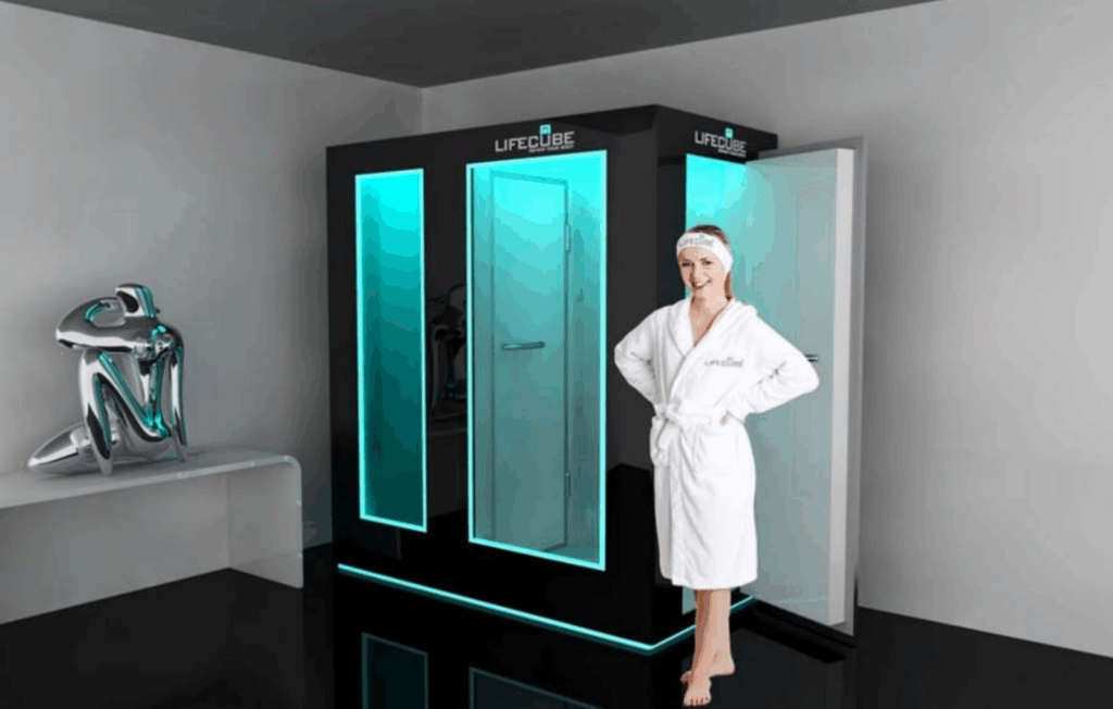 Person standing in a whole-body cryotherapy chamber at a wellness clinic, surrounded by cold mist.