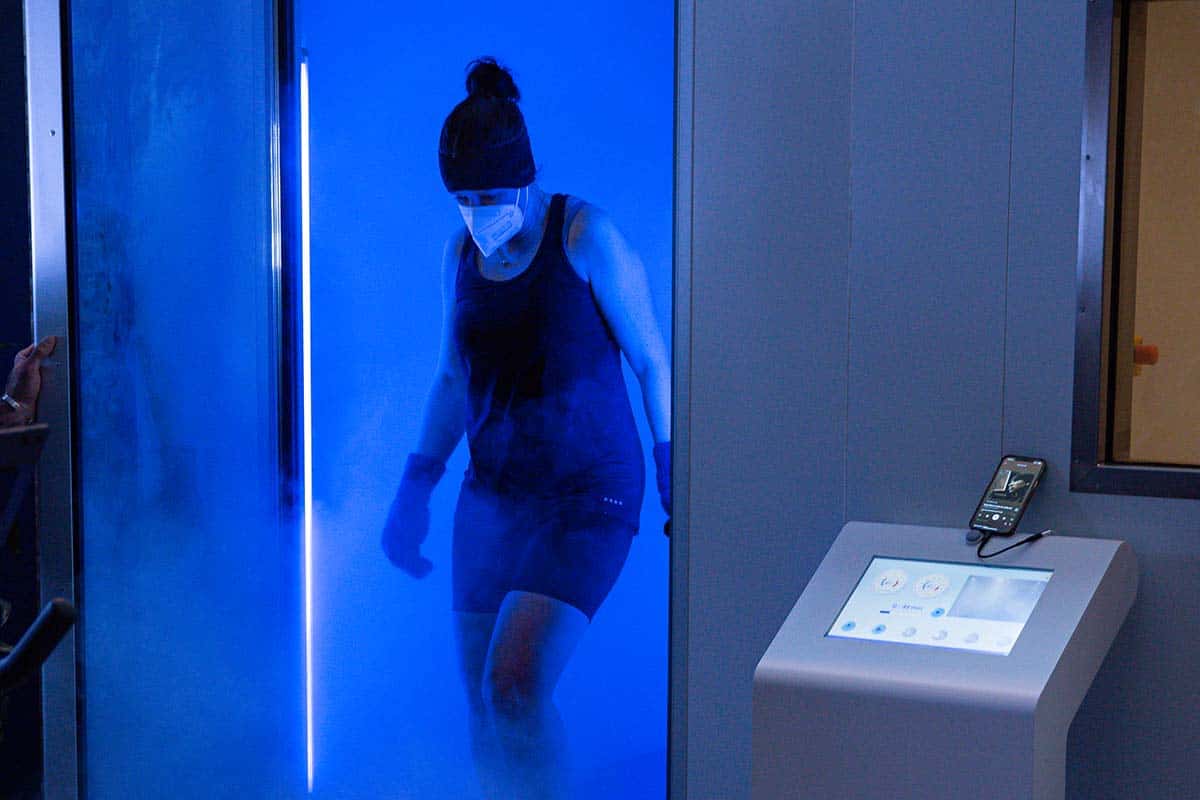 Client entering whole body cryotherapy chamber at EK Cryo Finchley